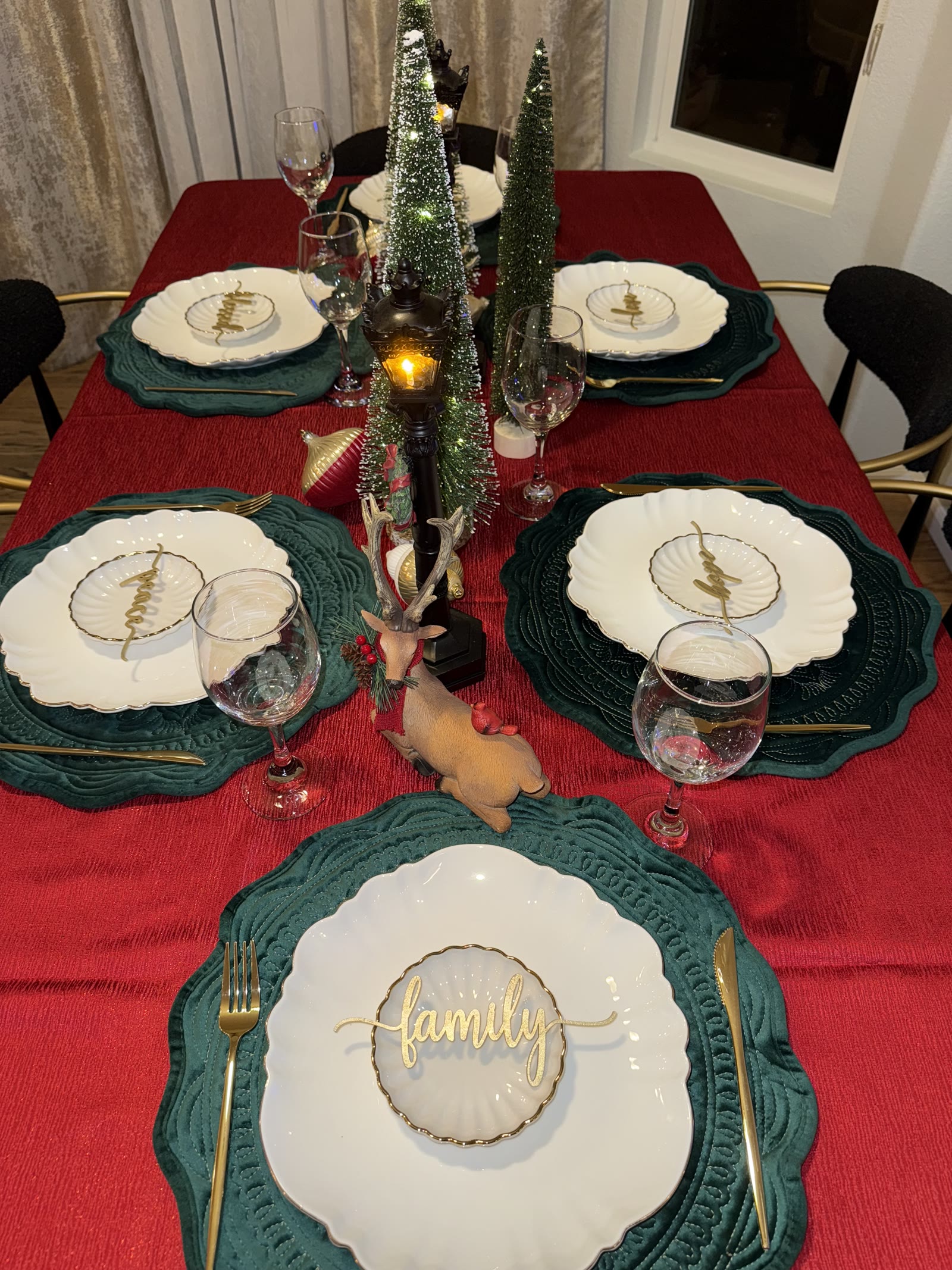 Styled main table with green plates, gold flatware and a family place setting
